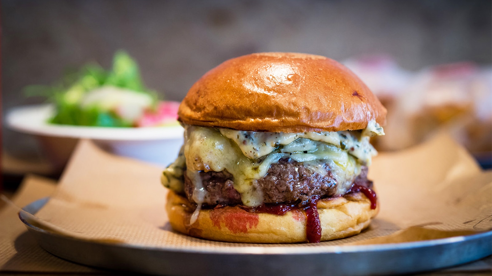 Peaky Blinders Manchester - Peaky Signature Burger ⁠ Ground brisket &  chunk steak patty, golden caramelised onions, black wax cheddar, shredded  lettuce and Peaky burger sauce. Perfectly paired with a cold pint