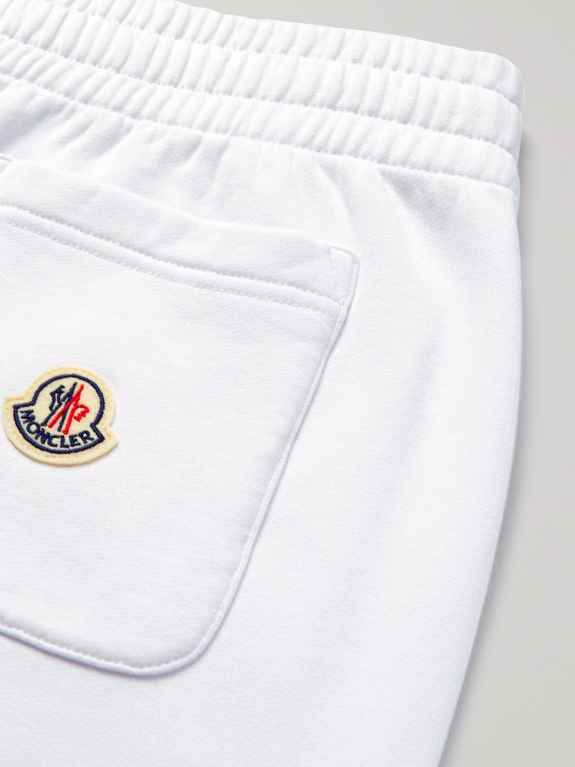 Shop Moncler Tapered Logo-print Cotton-jersey Sweatpants In White