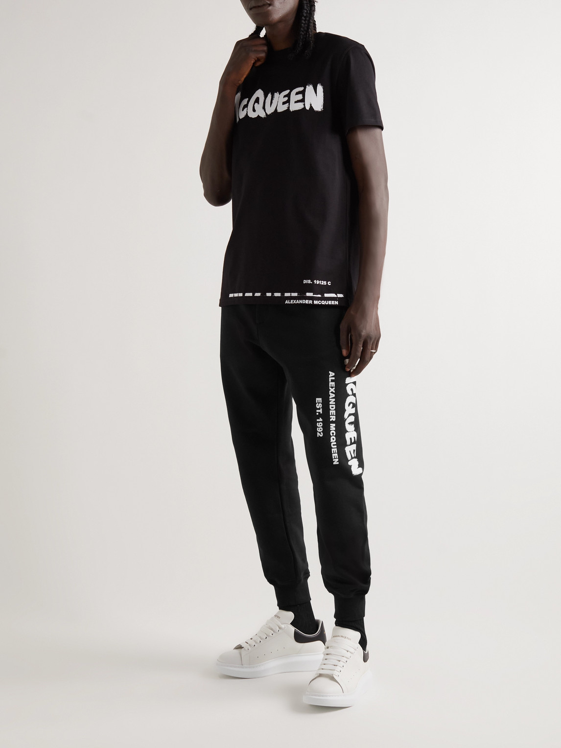 Shop Alexander Mcqueen Tapered Logo-print Loopback Cotton-jersey Sweatpants In Black