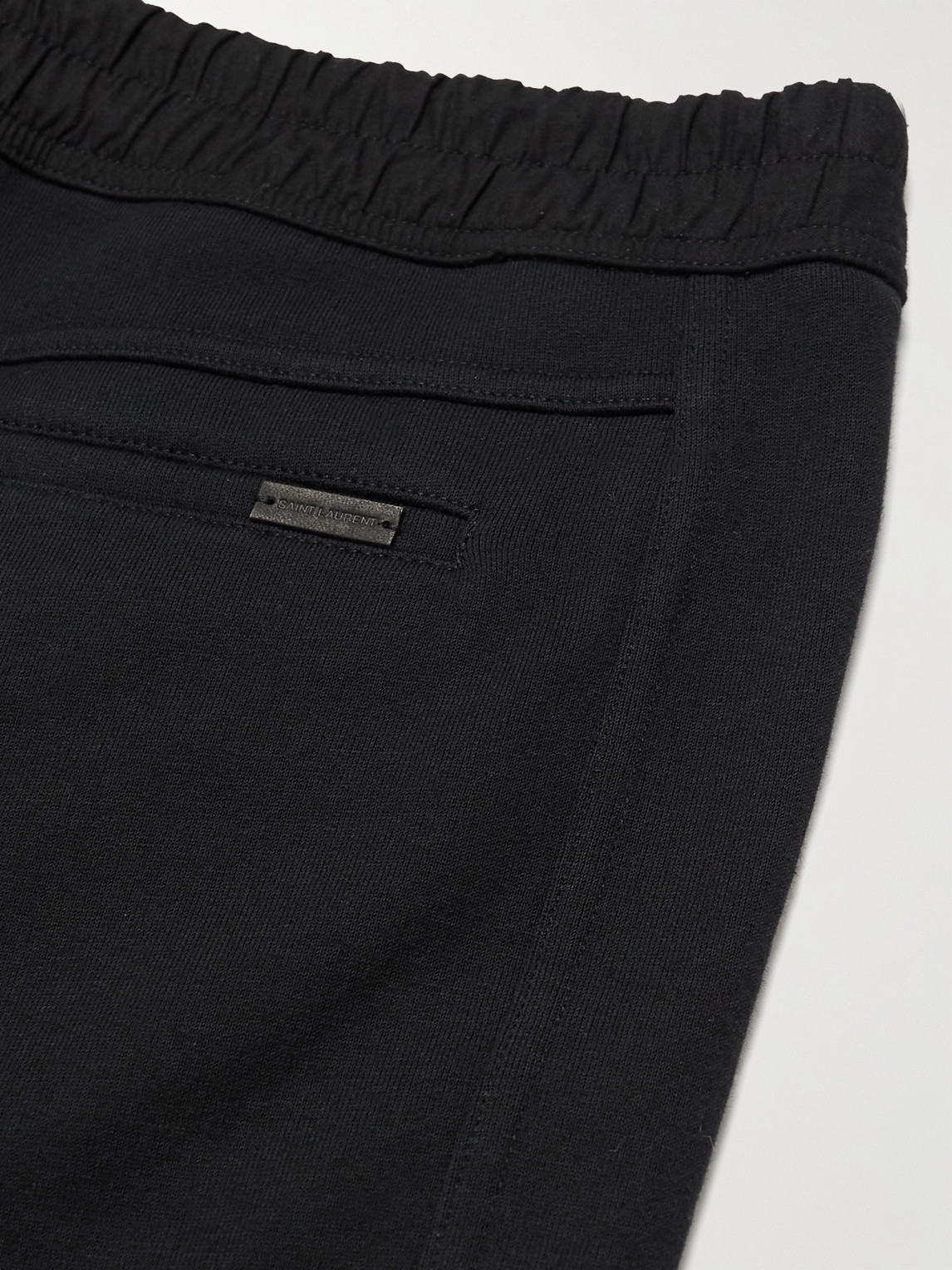 Shop Saint Laurent Tapered Logo-embroidered Cotton-jersey Sweatpants In Black