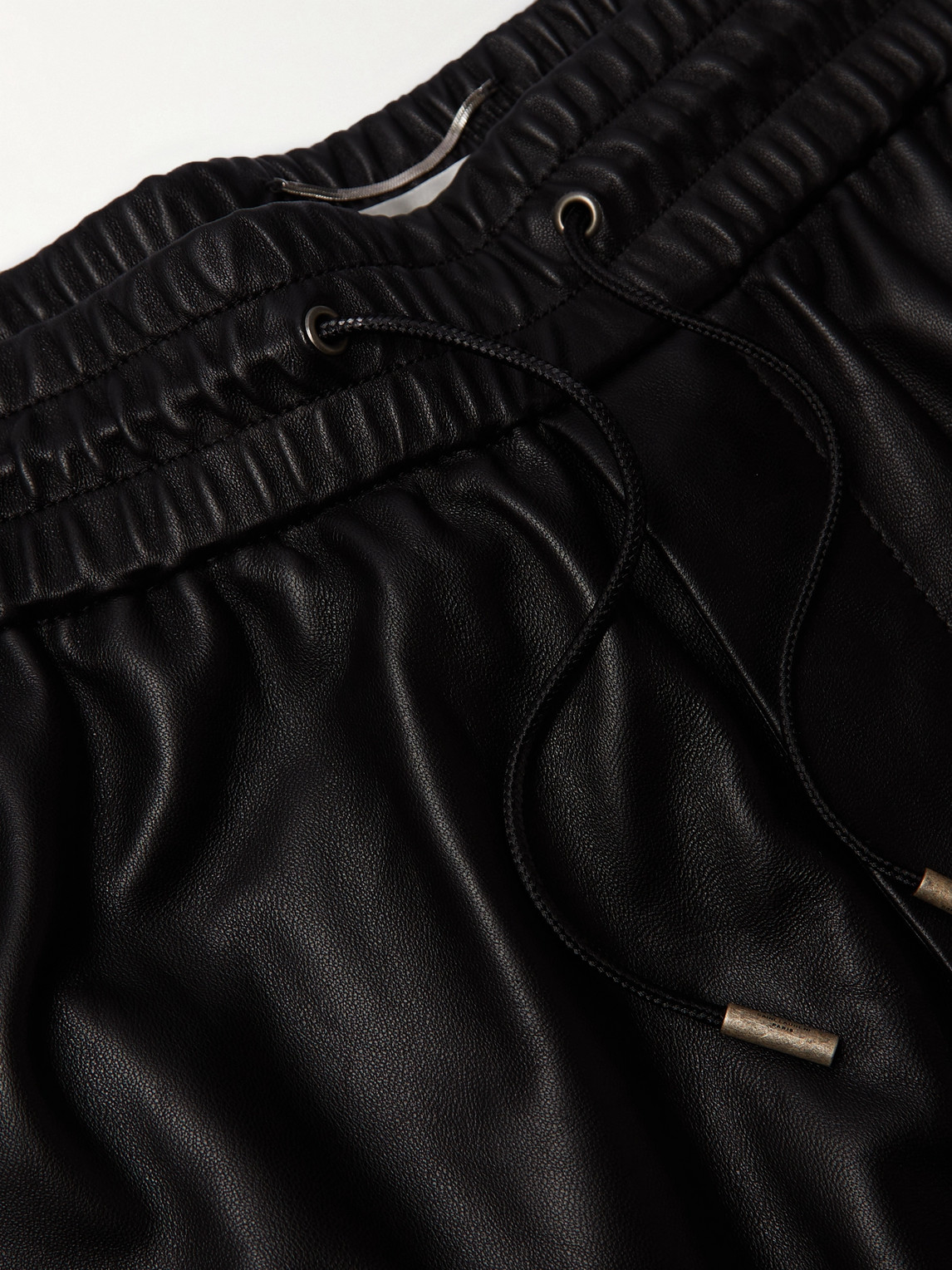Shop Saint Laurent Tapered Leather Sweatpants In Black