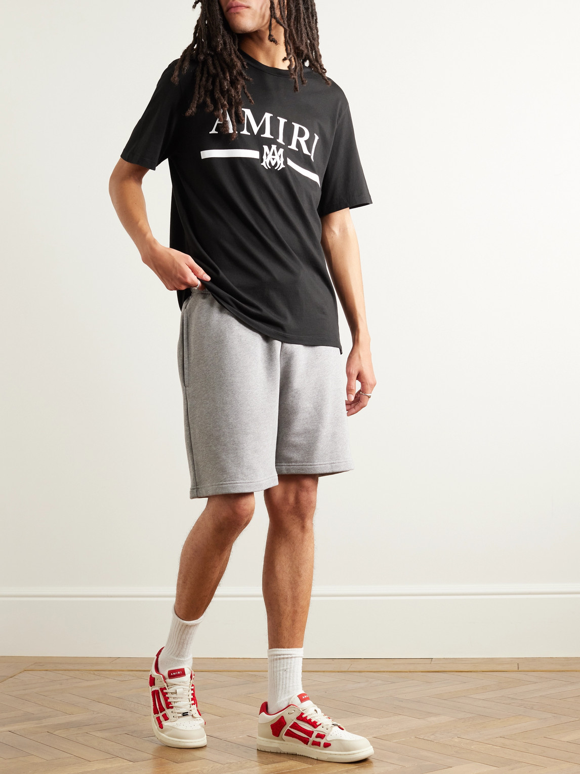 Shop Amiri Logo-appliquéd Cotton-jersey T-shirt In Black