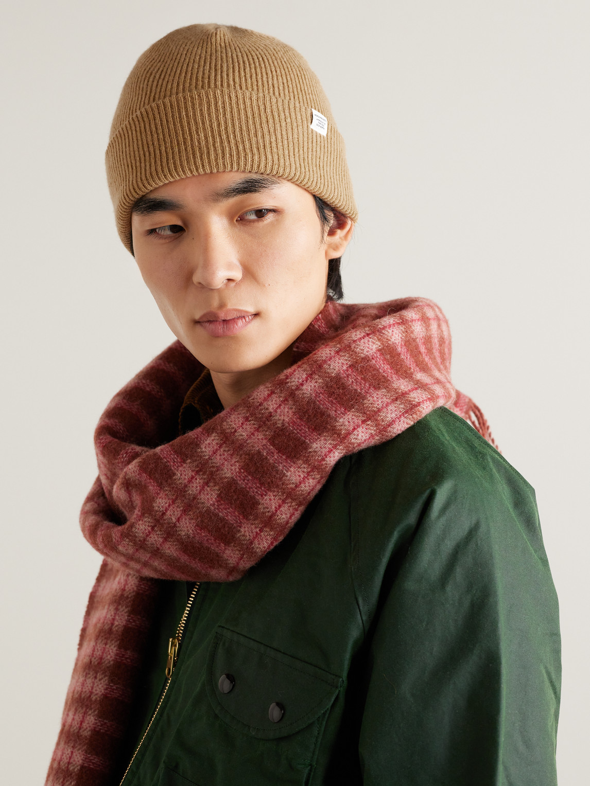 Shop Norse Projects Logo-appliquéd Ribbed Merino Wool Beanie In Brown
