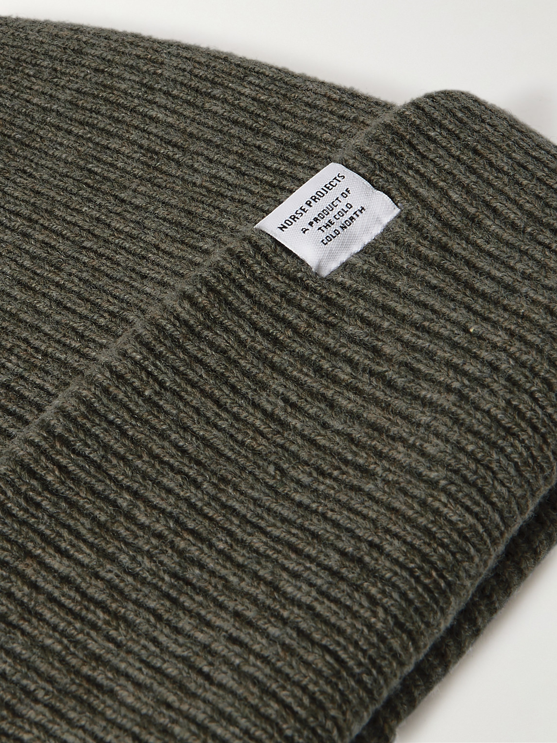Shop Norse Projects Logo-appliquéd Ribbed Merino Wool Beanie In Green