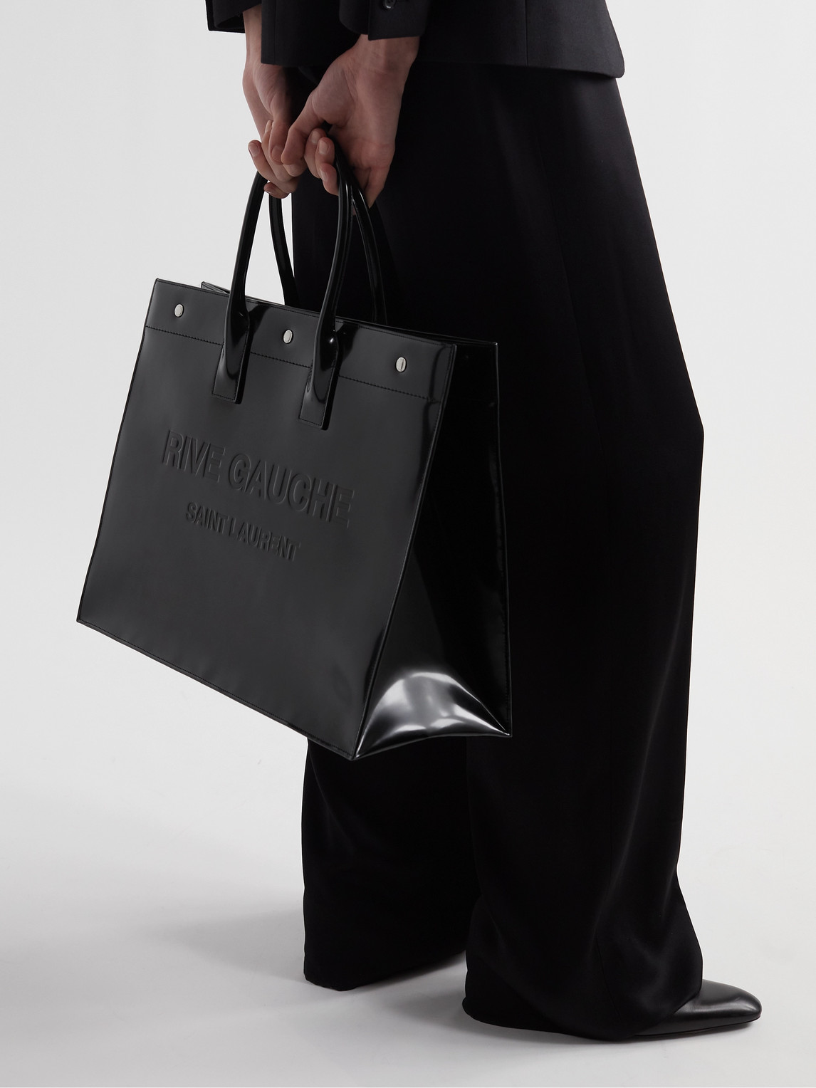 Shop Saint Laurent Rive Gauche Logo-embossed Glossed-leather Tote Bag In Black