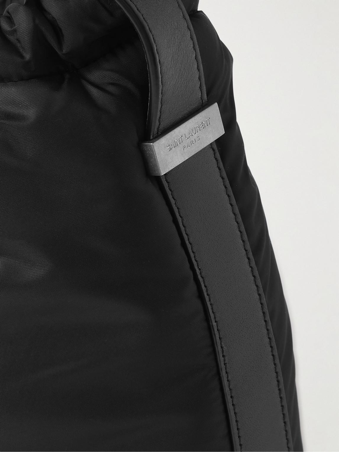 Shop Saint Laurent Rive Gauche Logo-debossed Padded Nylon Bucket Bag In Black