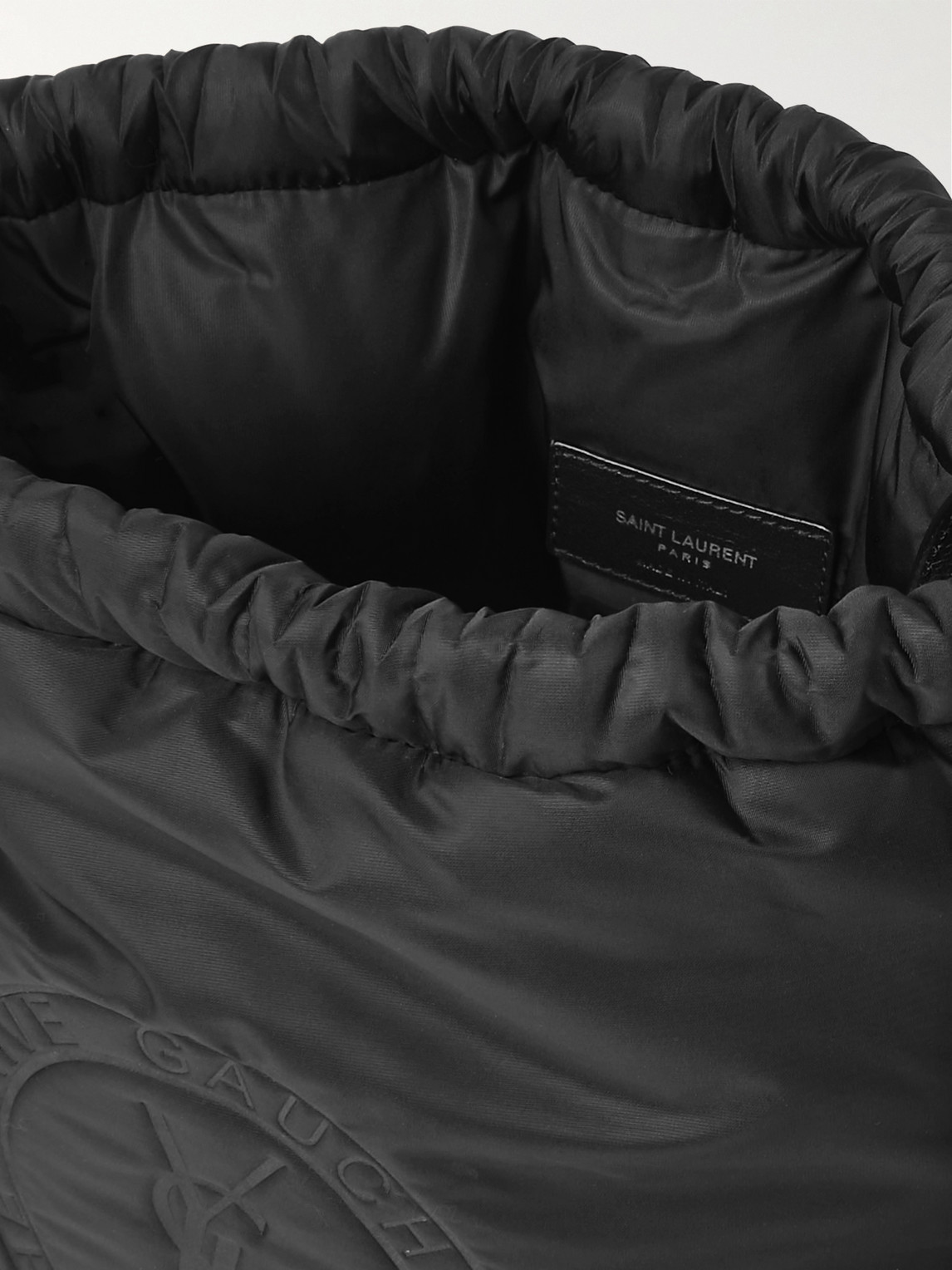 Shop Saint Laurent Rive Gauche Logo-debossed Padded Nylon Bucket Bag In Black