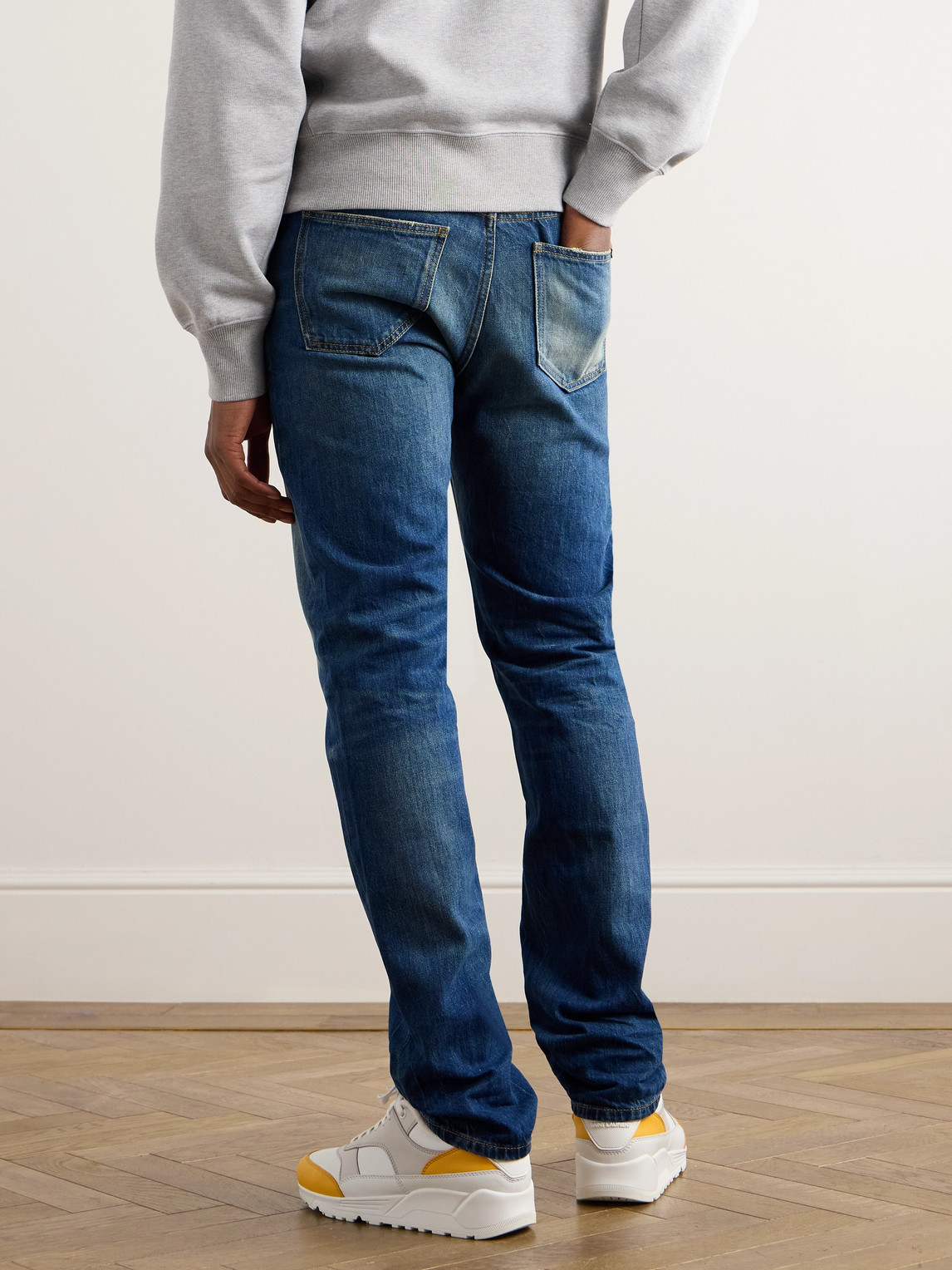 Shop Saint Laurent Straight-leg Distressed Jeans In Gold
