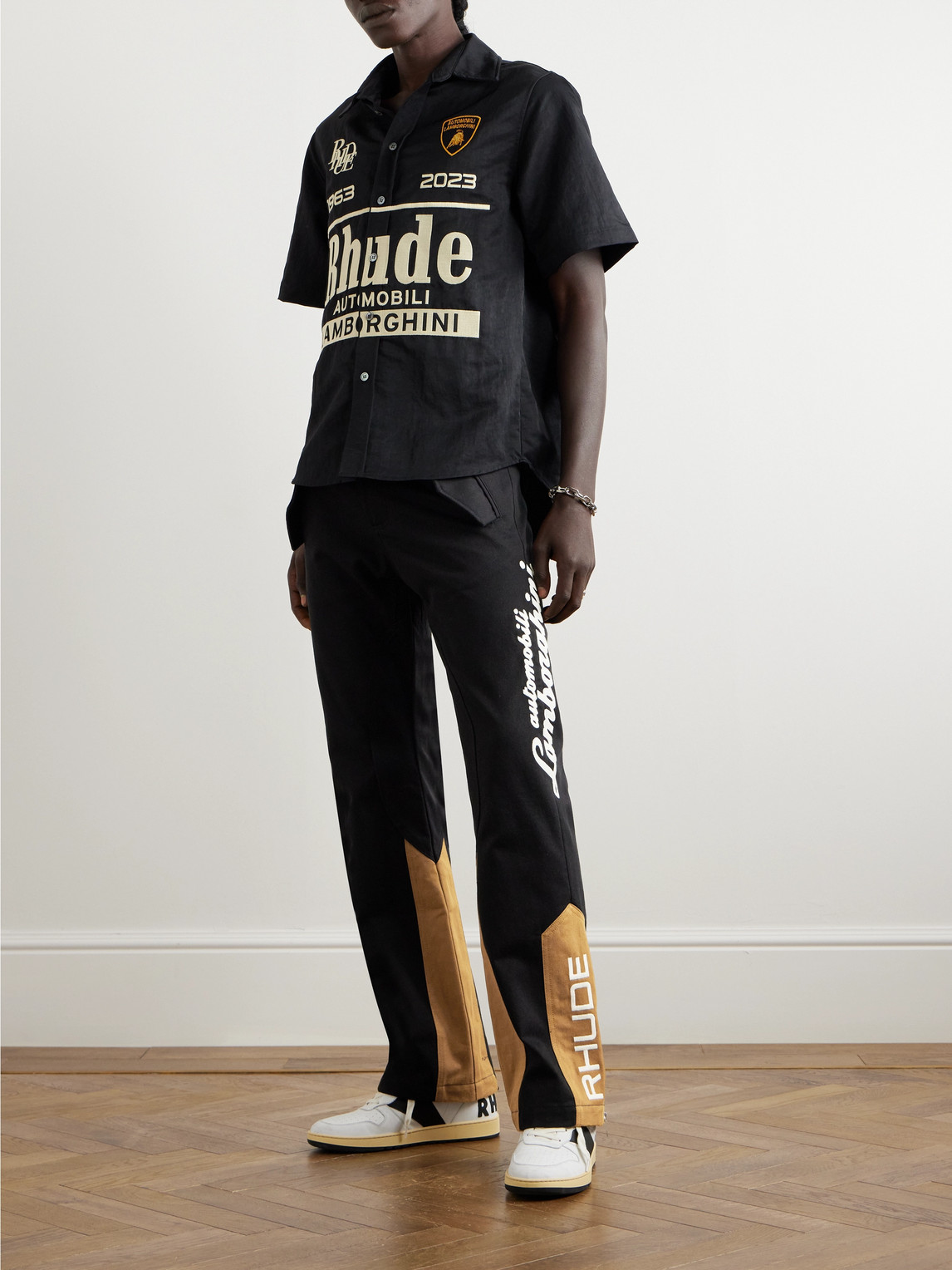 Shop Rhude Lamborghini Printed Panelled Straight-leg Cotton-twill Trousers In Black