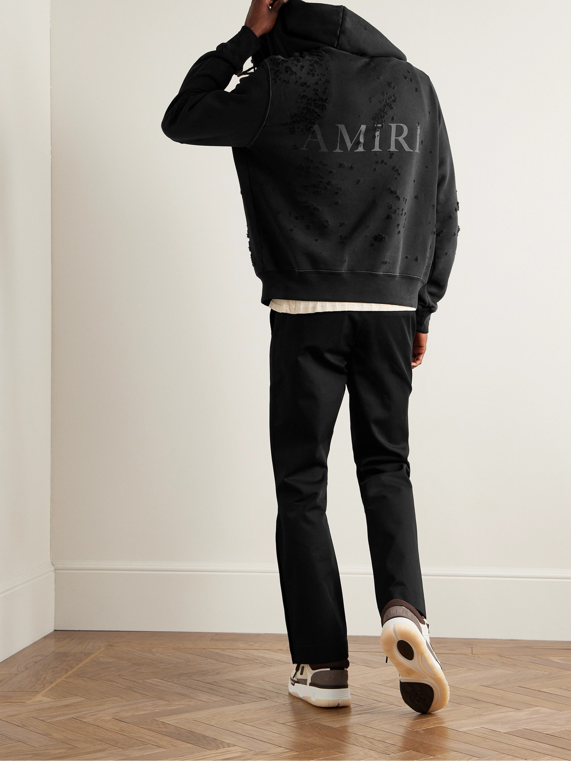 Shop Amiri Distressed Logo-print Cotton-jersey Zip-up Hoodie In Black