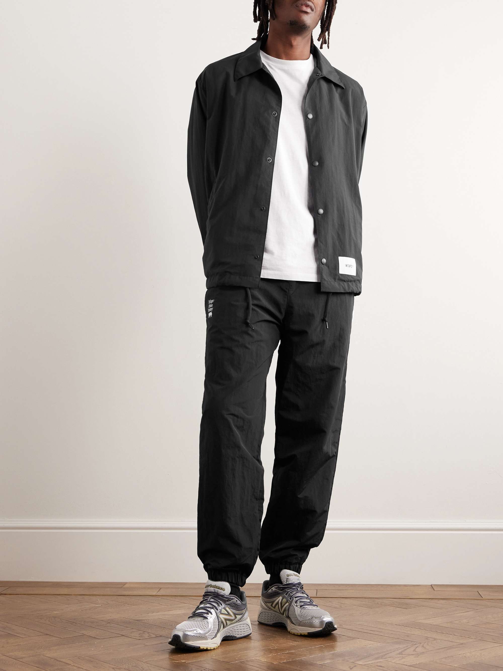 WTAPS® Logo-Print Tapered Nylon Drawstring Trousers for Men | MR PORTER