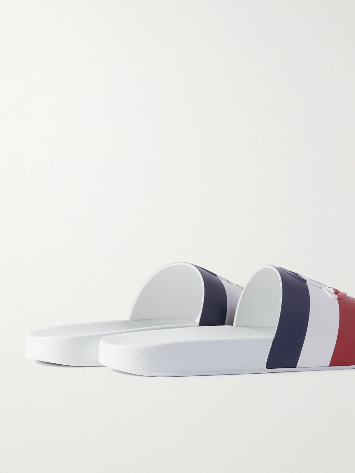 Shop Moncler Basile Logo-embossed Striped Rubber Slides In White