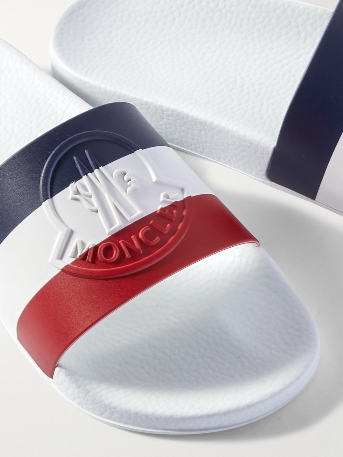 Shop Moncler Basile Logo-embossed Striped Rubber Slides In White