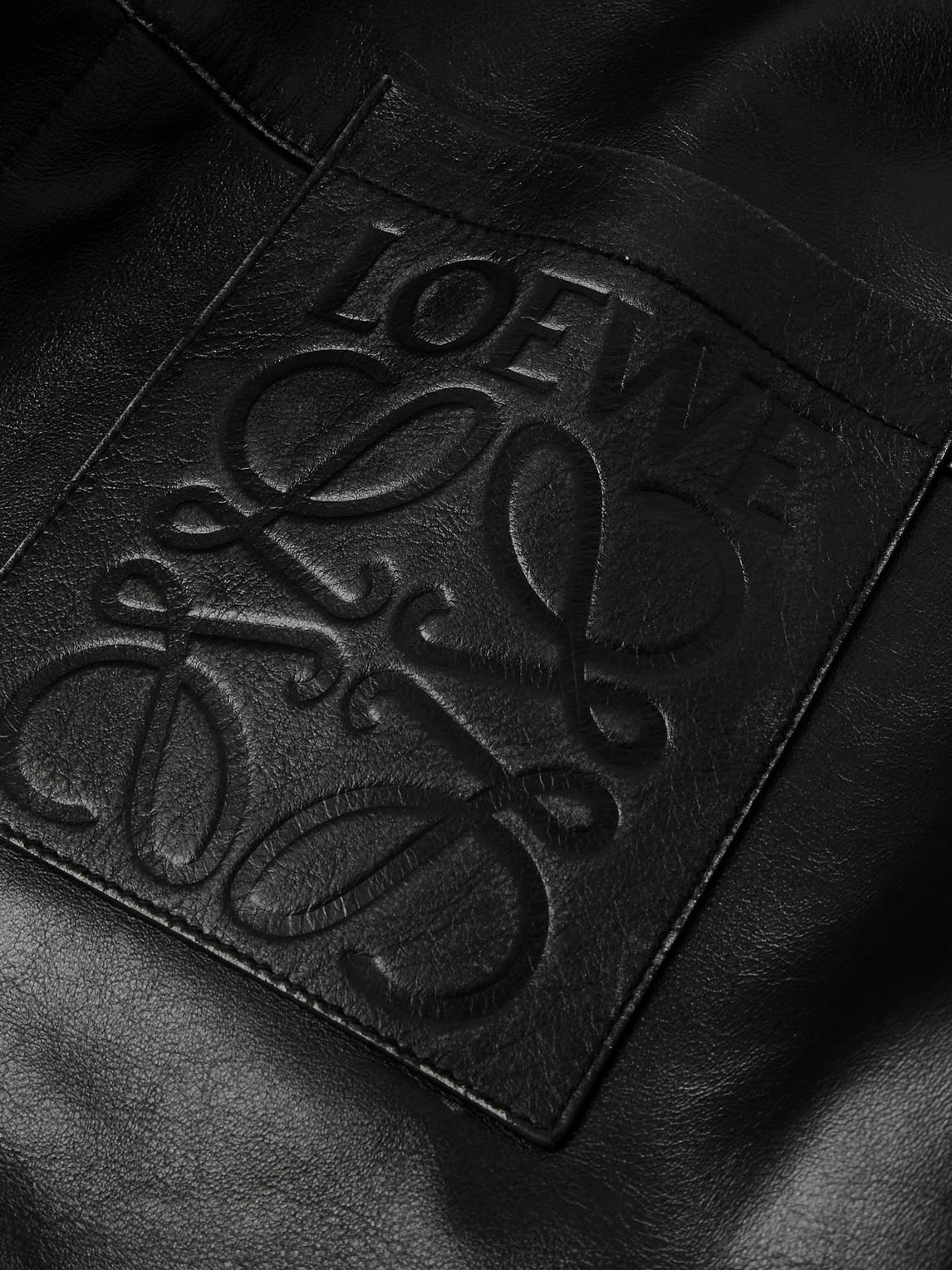 Shop Loewe Logo-embossed Distressed Leather Jacket In Black