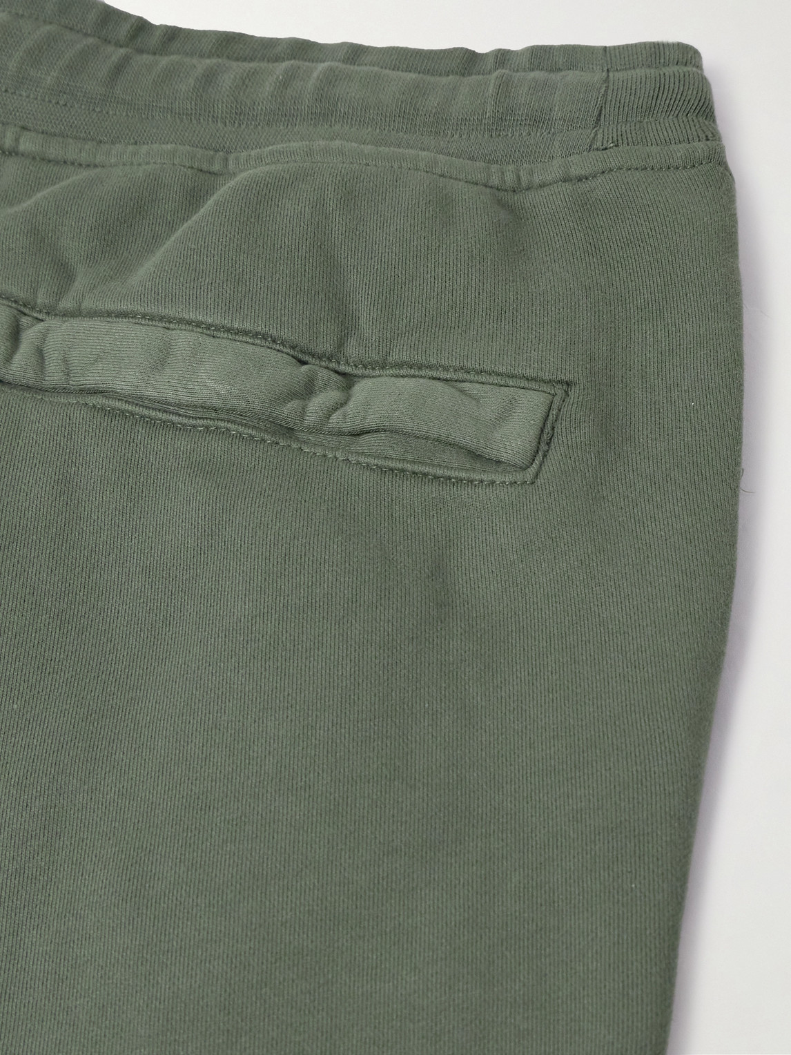 Shop Stone Island Tapered Logo-appliquéd Garment-dyed Cotton-jersey Sweatpants In Green