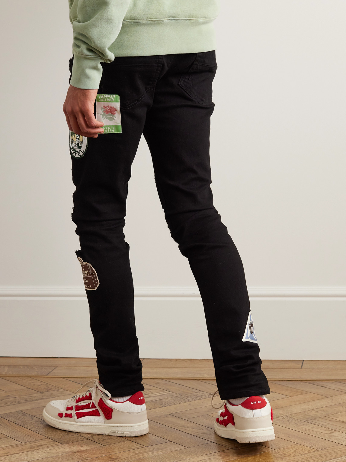 Shop Amiri Skinny-fit Appliquéd Distressed Jeans In Black