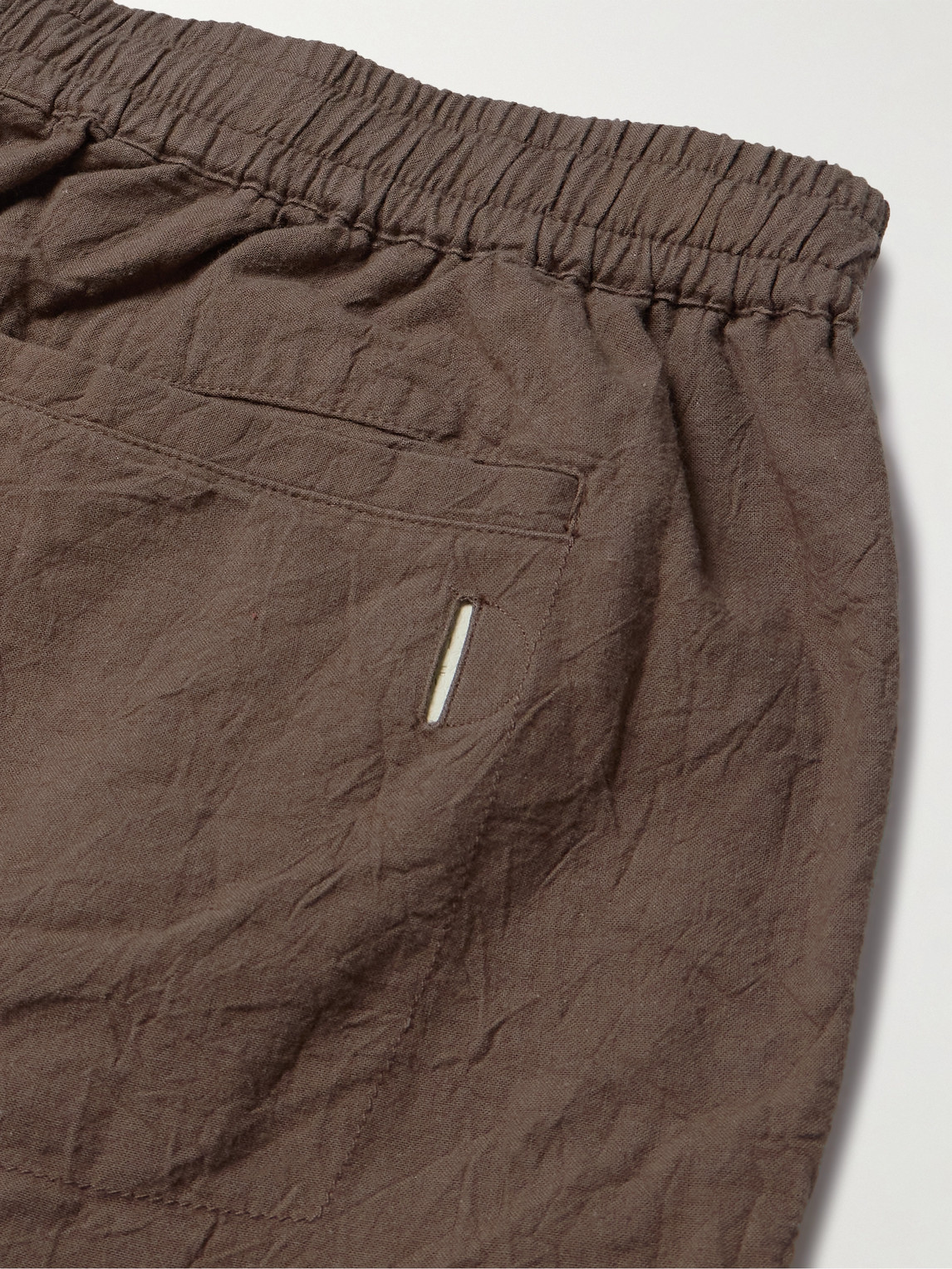 Shop Folk Assembly Tapered Crinkled-cotton Trousers In Brown