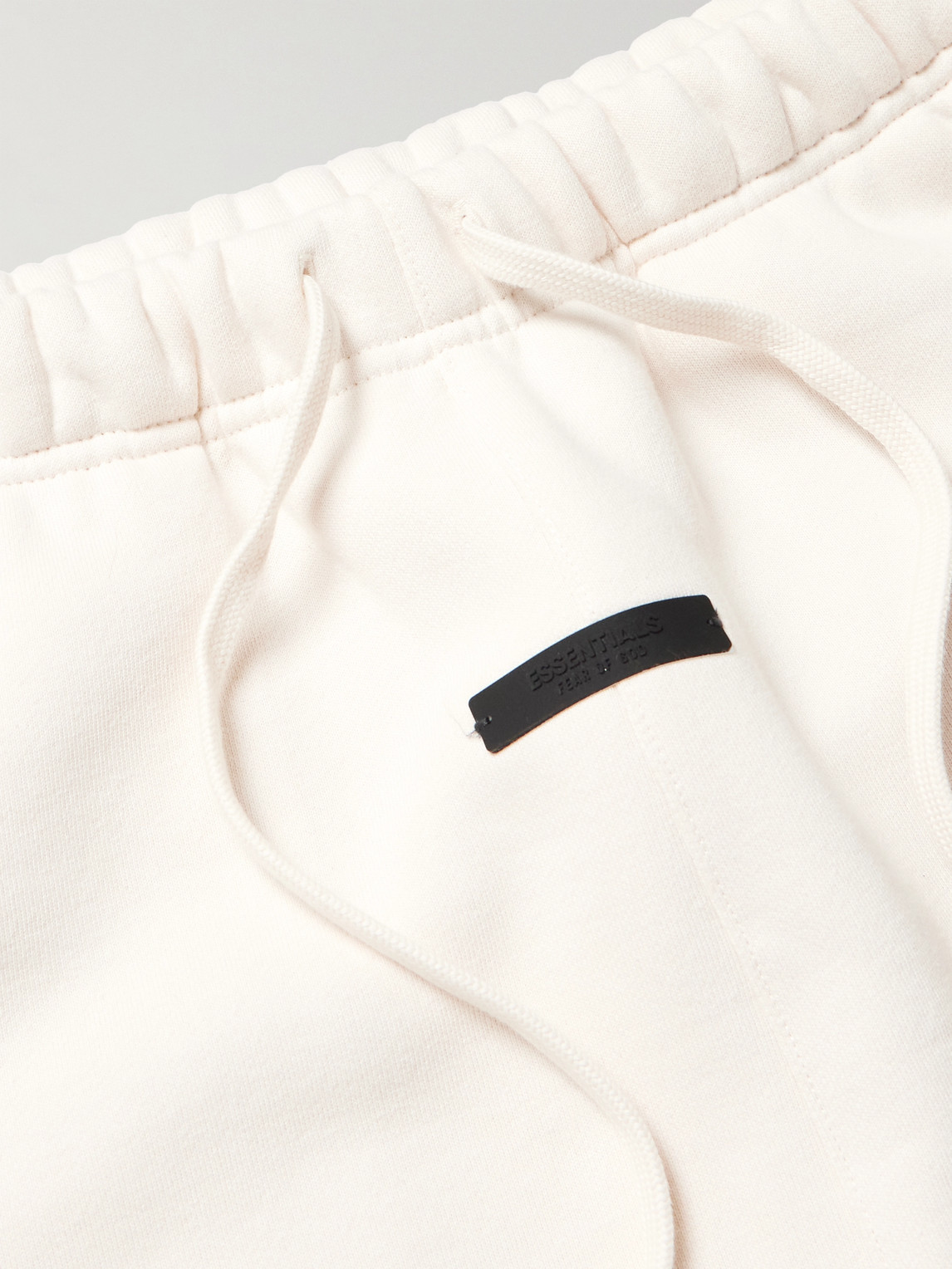 Essentials Tapered Logo-print Appliquéd Cotton-blend Jersey Sweatpants In White