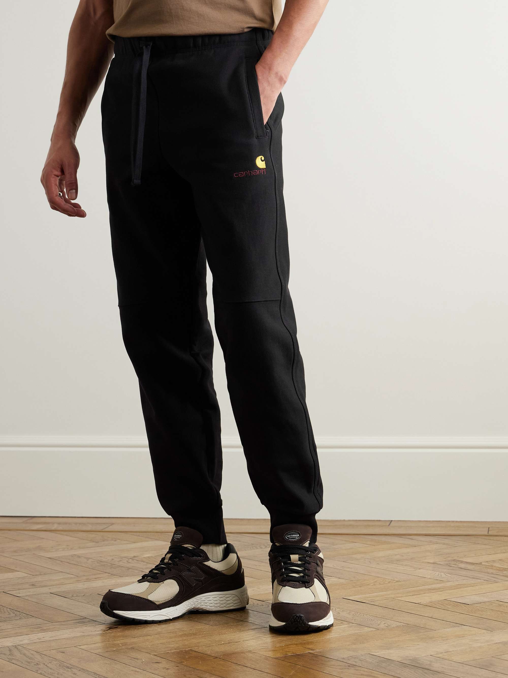 CARHARTT WIP Pantaloni sportivi a gamba affusolata in jersey di misto cotone American Script