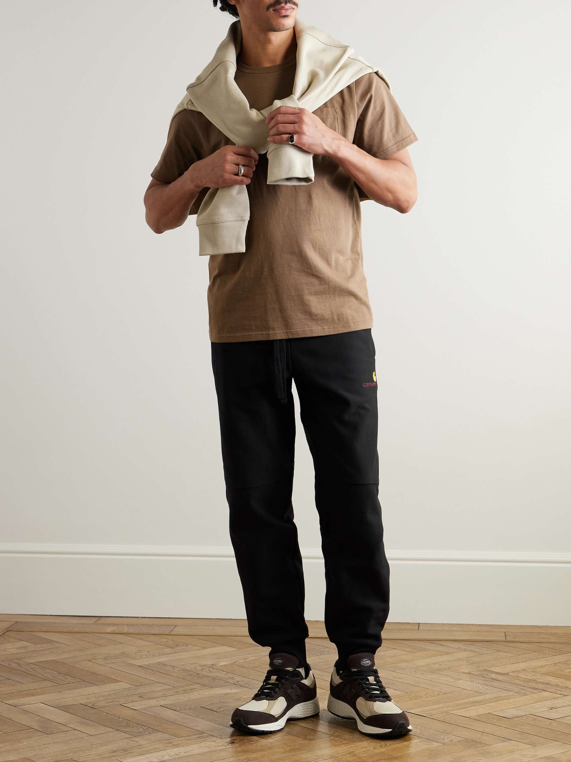 CARHARTT WIP Pantaloni sportivi a gamba affusolata in jersey di misto cotone American Script