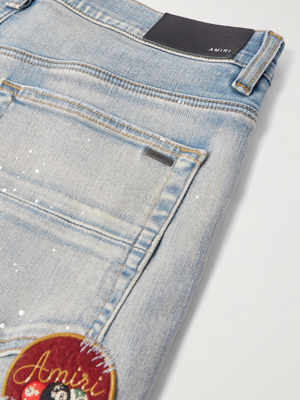 Shop Amiri Skinny-fit Appliquéd Distressed Paint-splattered Jeans In Blue