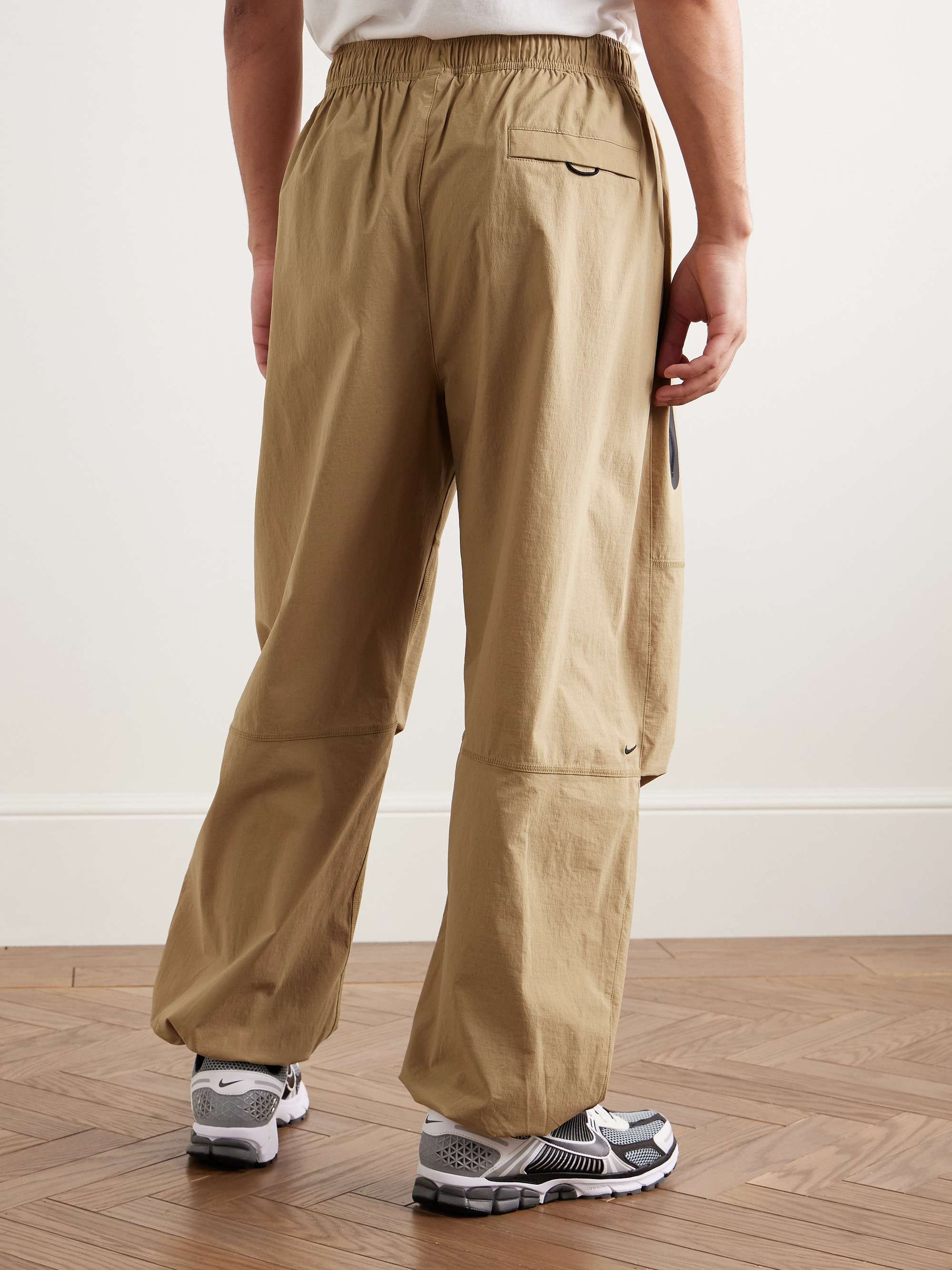 NIKE Tech Wide-Leg Pleated Logo-Print Stretch-Nylon Trousers