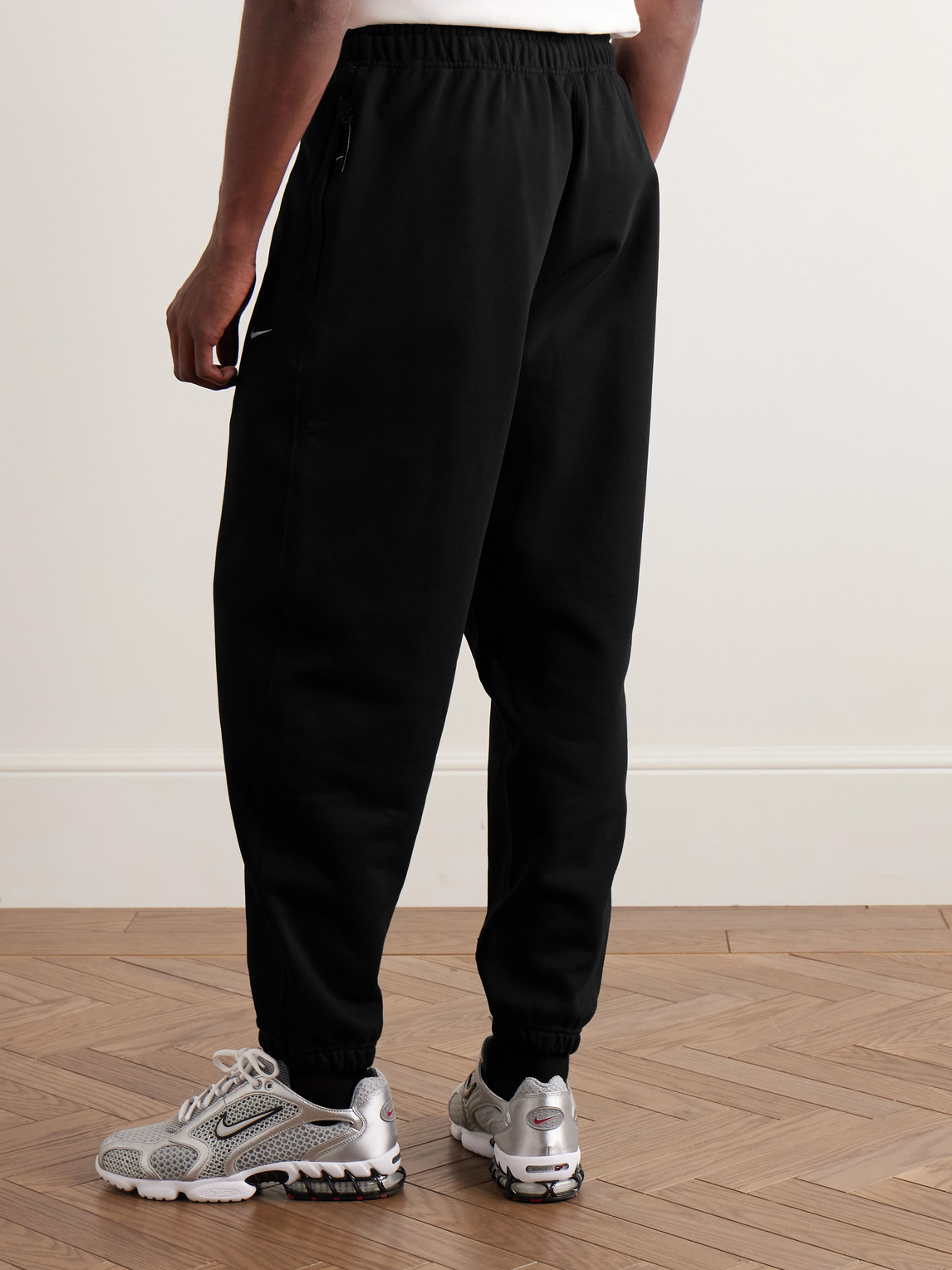 Nike Solo Swoosh Tapered Logo-embroidered Cotton-blend Jersey Sweatpants In Black