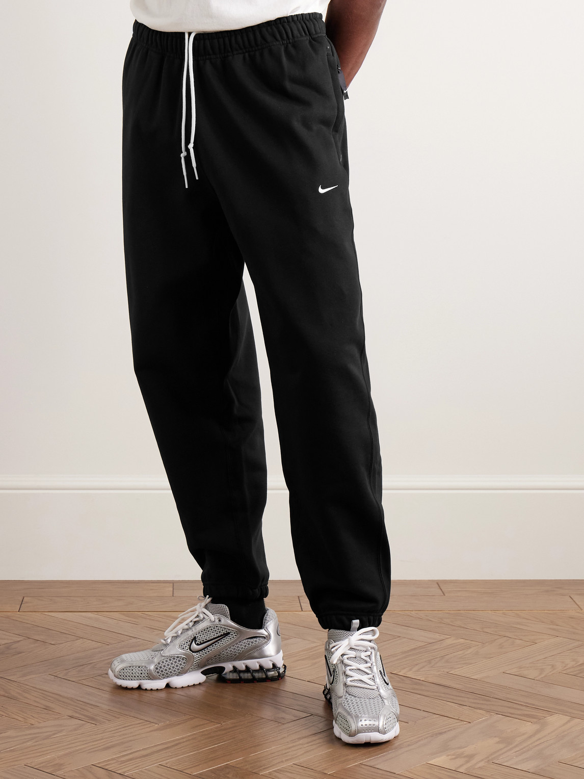 Nike Solo Swoosh Tapered Logo-embroidered Cotton-blend Jersey Sweatpants In Black
