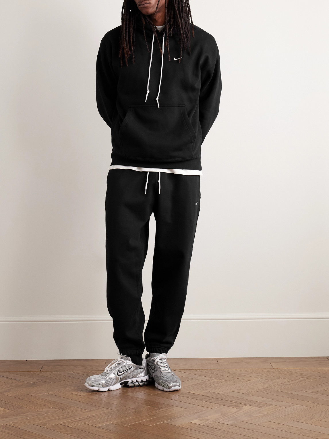 Nike Solo Swoosh Tapered Logo-embroidered Cotton-blend Jersey Sweatpants In Black