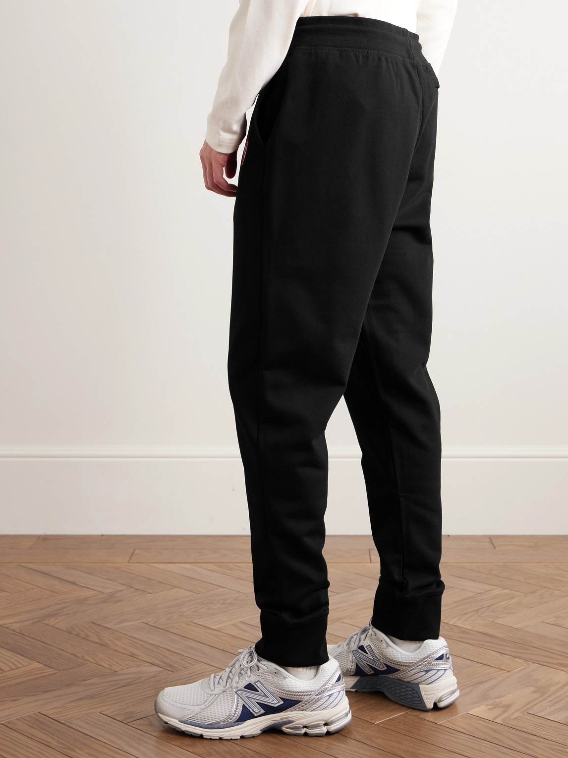 Shop Canada Goose Huron Tapered Logo-appliquéd Cotton-jersey Sweatpants In Black