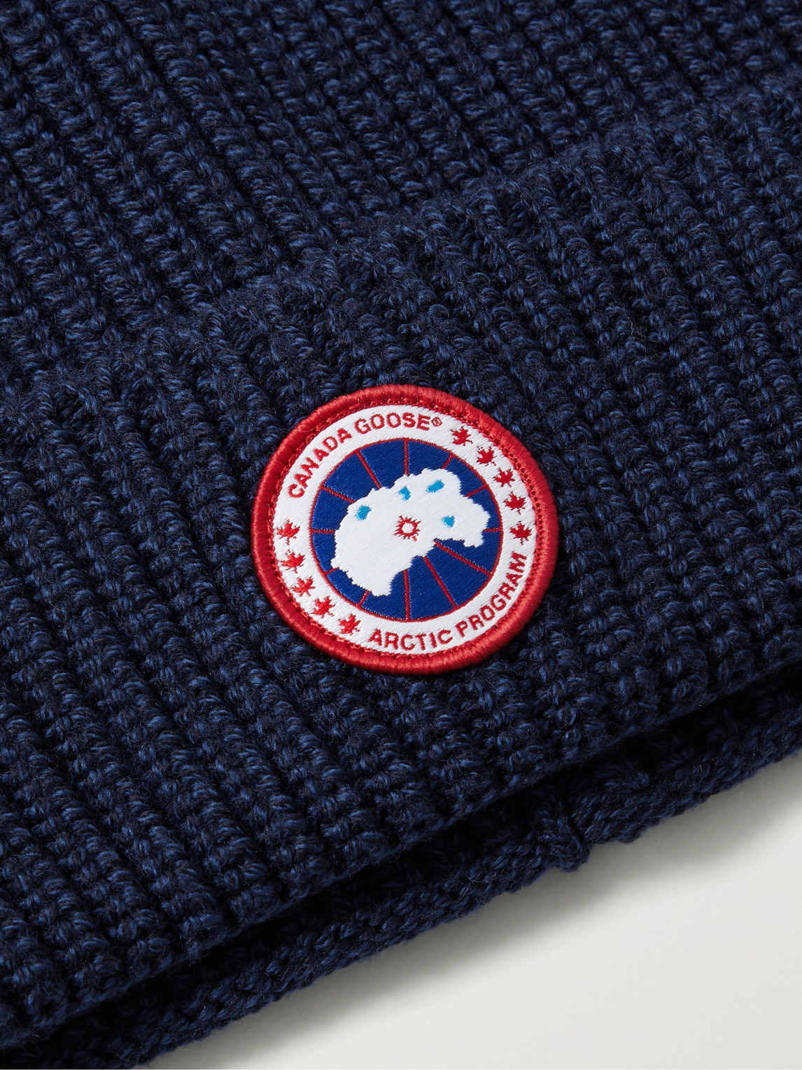 Shop Canada Goose Logo-appliquéd Ribbed Wool Beanie In Blue
