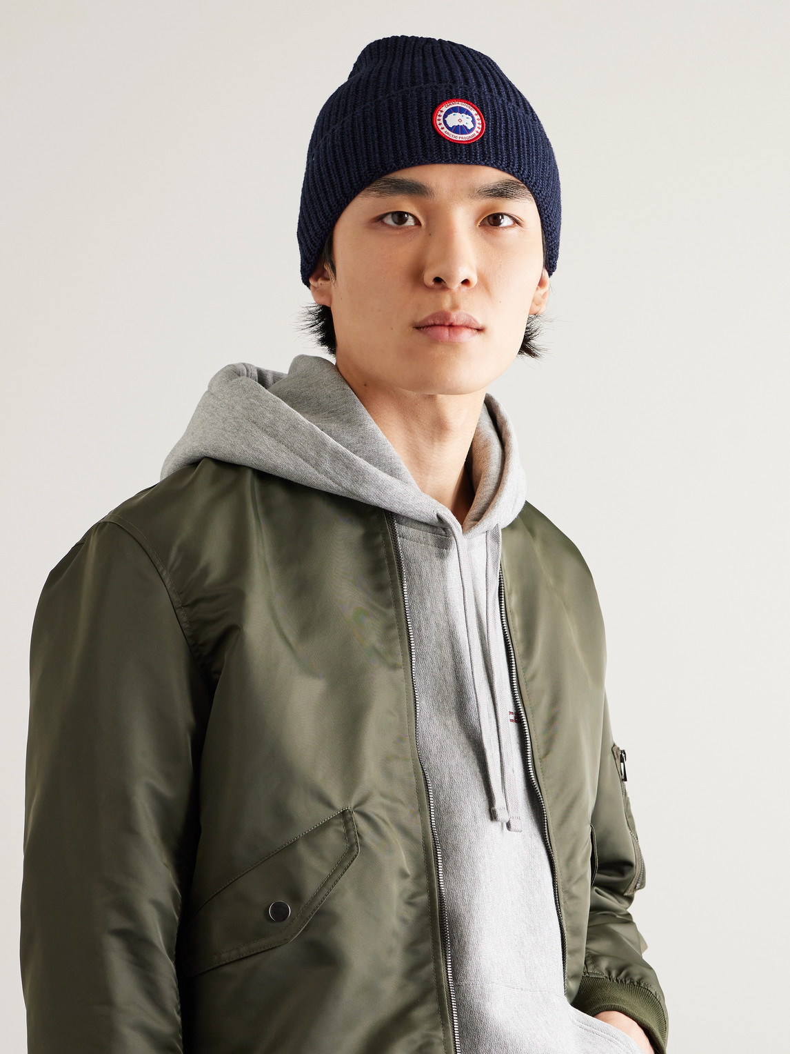 Shop Canada Goose Logo-appliquéd Ribbed Wool Beanie In Blue