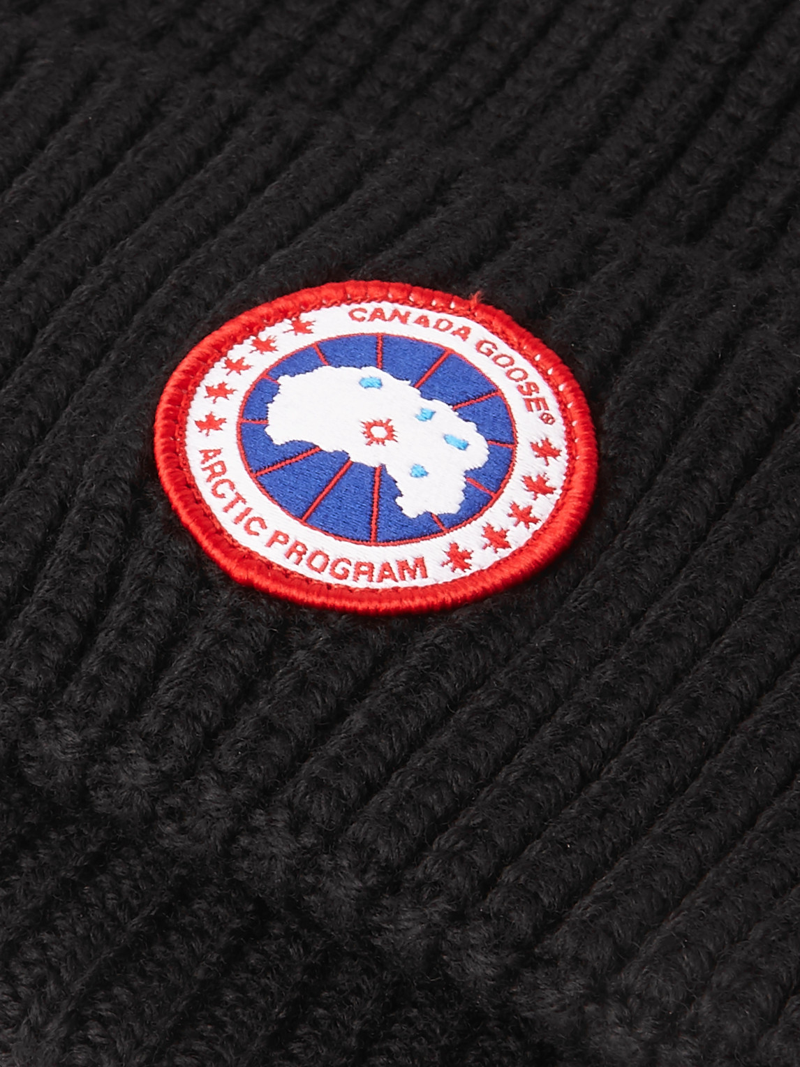 Shop Canada Goose Logo-appliquéd Ribbed Merino Wool Beanie In Black