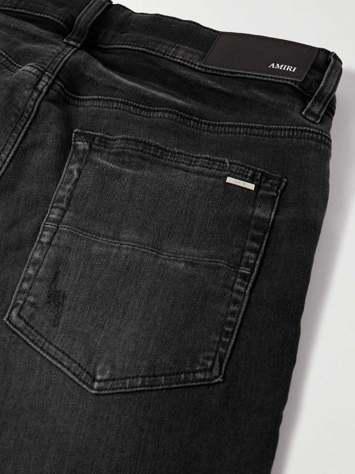 Amiri Hollywood Skinny-fit Logo-flocked Distressed Jeans In Black