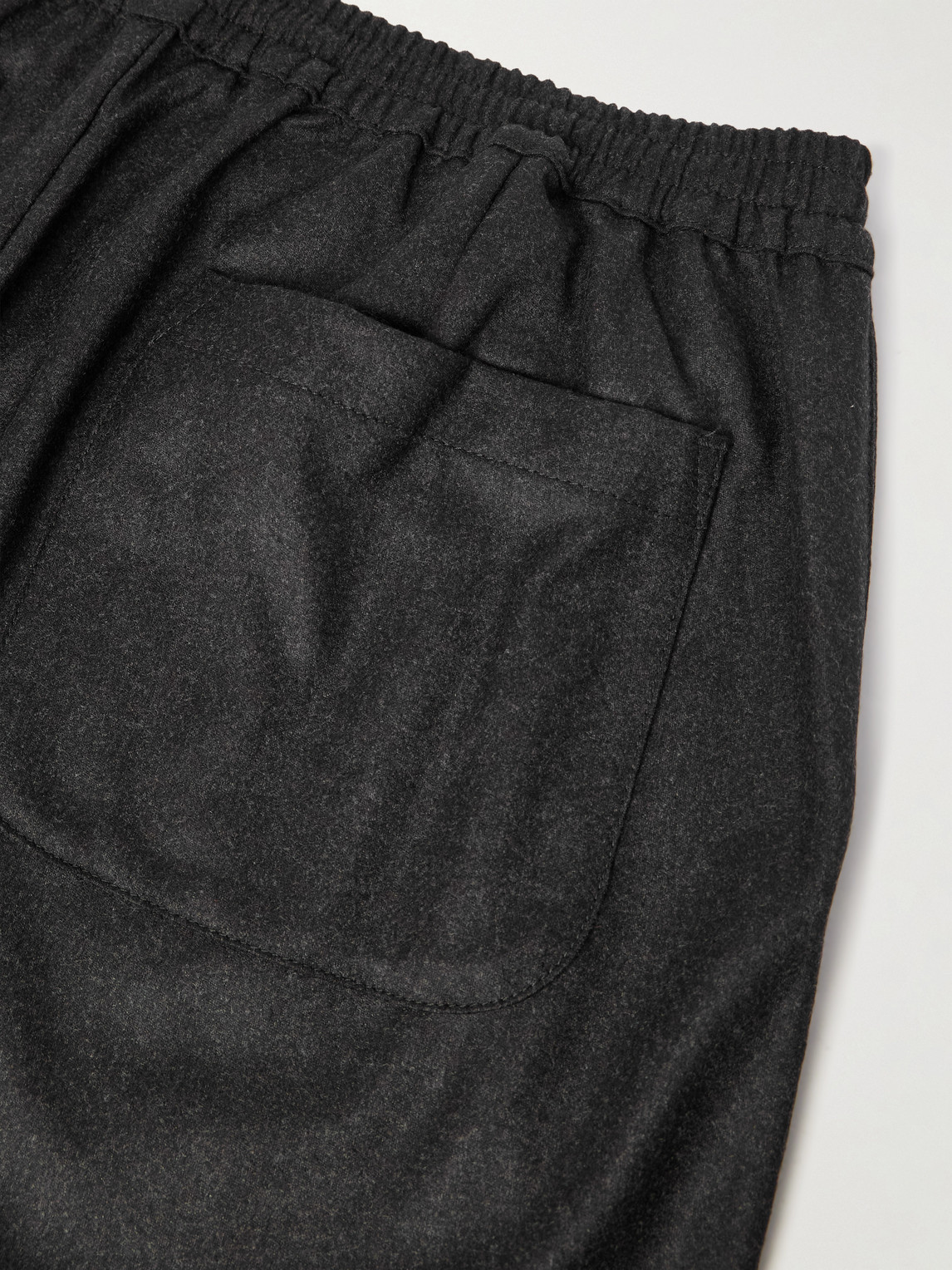 A Kind Of Guise Banasa Tapered Virgin Wool Trousers In Black