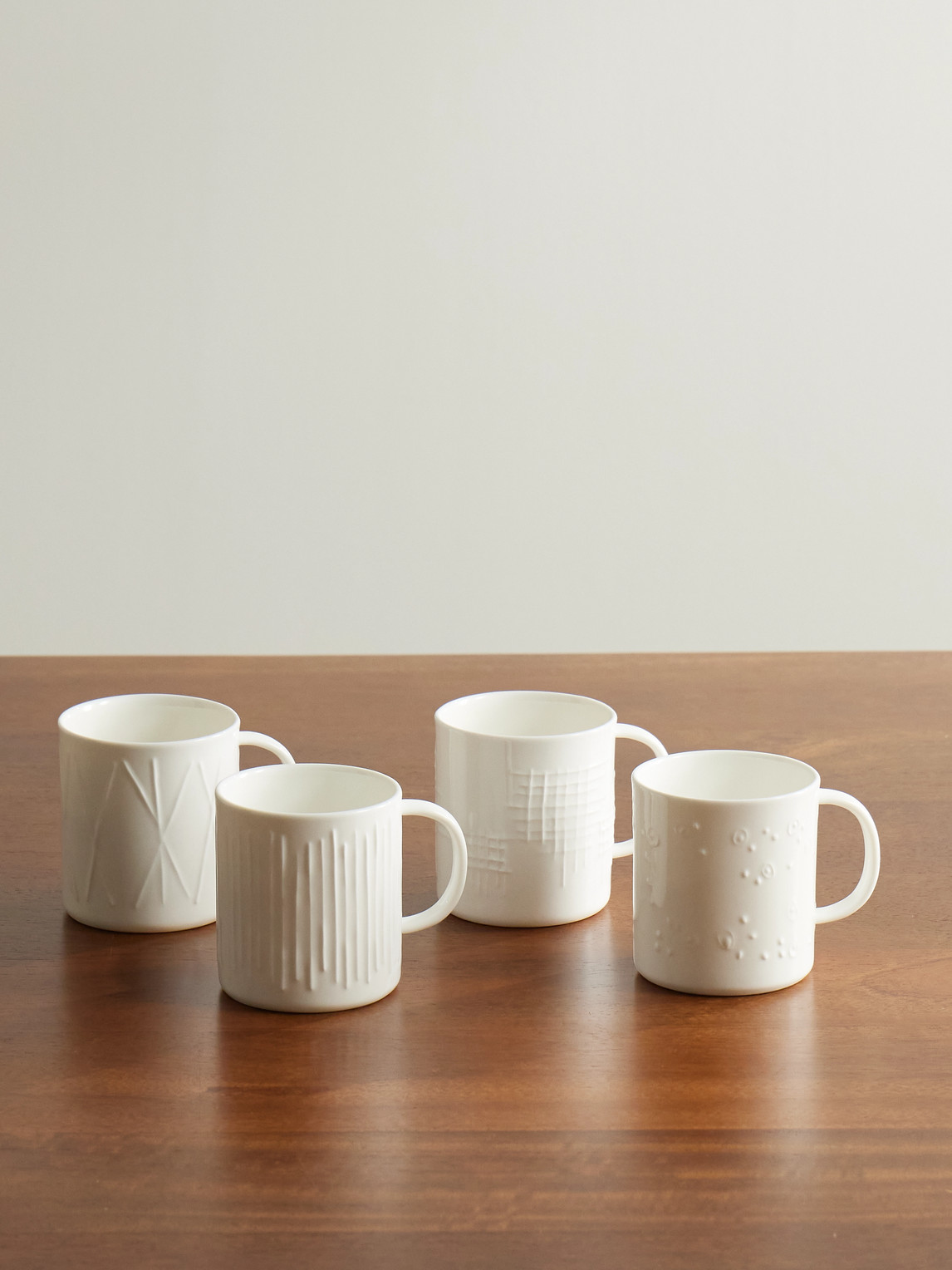 Set of Four Embossed Porcelain Mugs