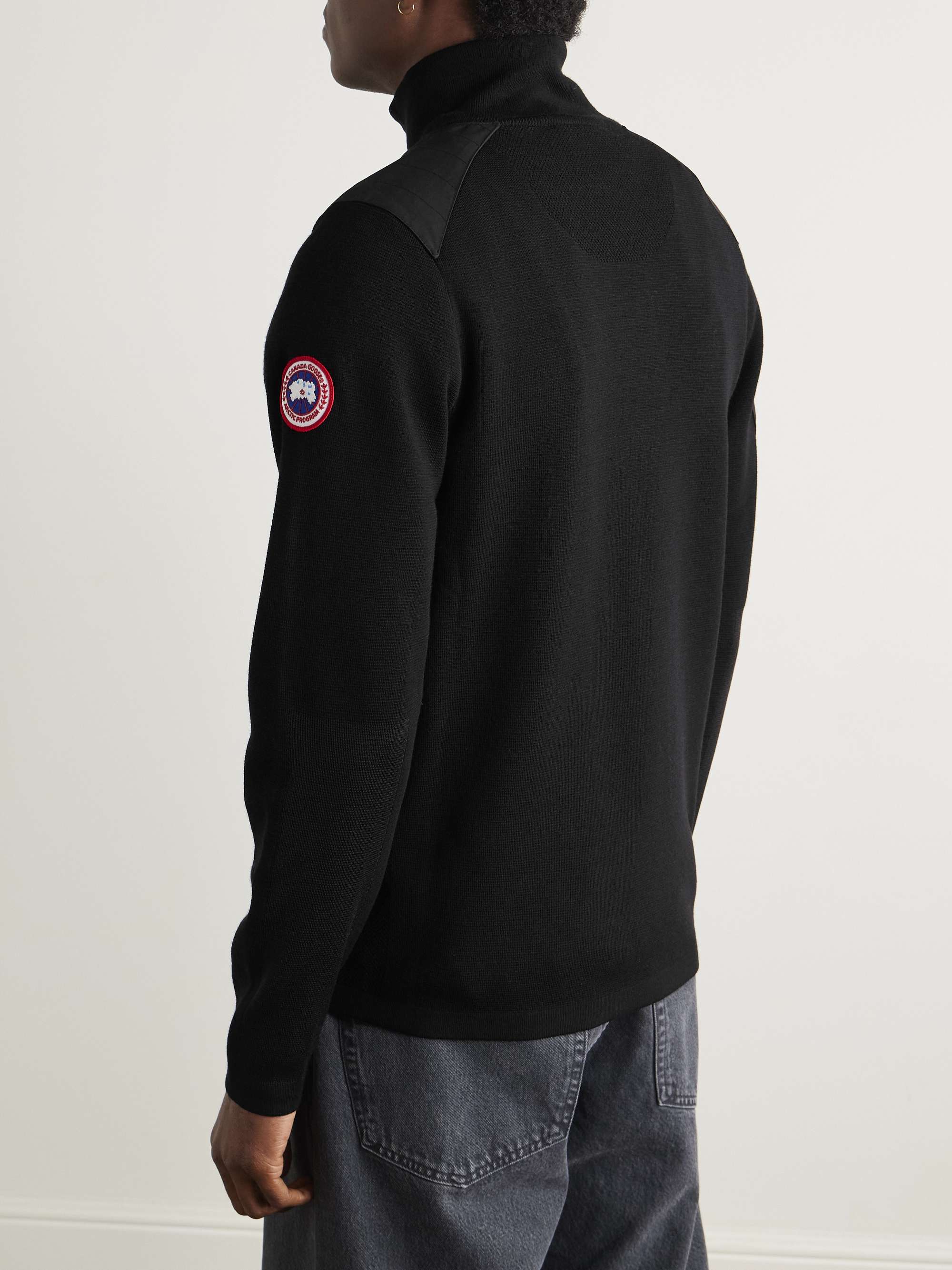 CANADA GOOSE كنزة Stormont بسحّاب نصفي وقصّة ضيّقة من صوف المارينو بحاشية من نسيج CORDURA