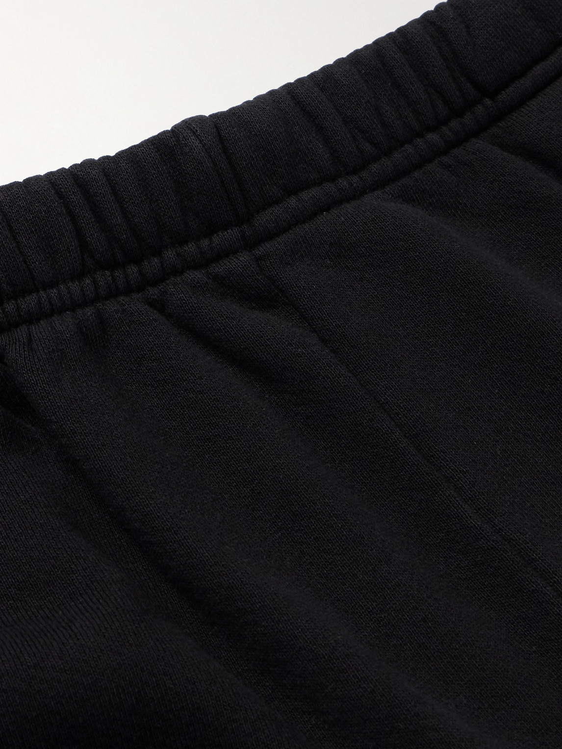 Shop Les Tien Tapered Garment-dyed Cotton-jersey Sweatpants In Black